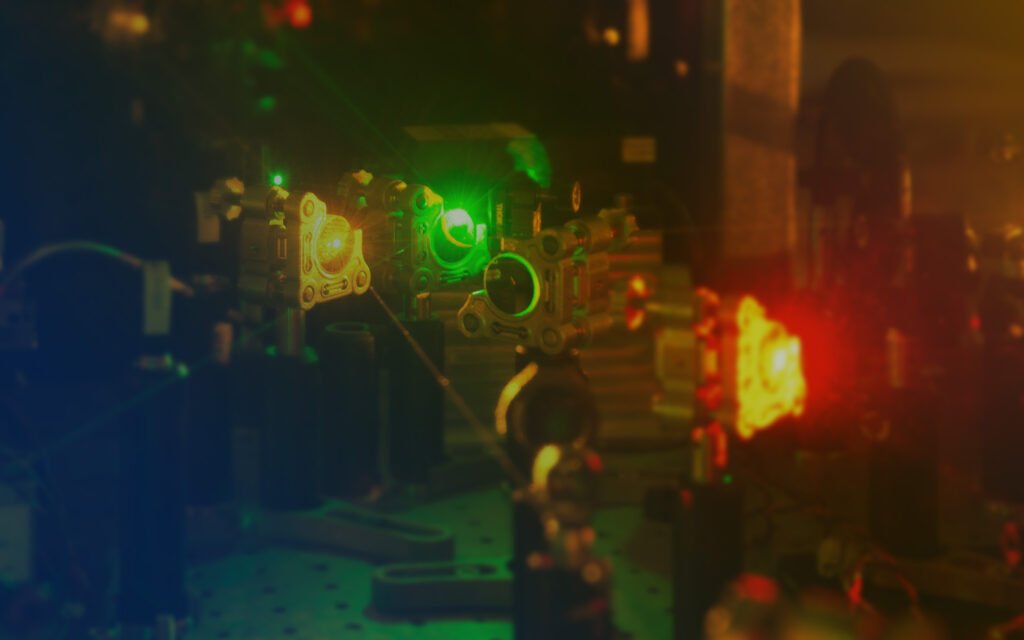 Real optical laboratory setup with lasers and photonics components — the physics foundation behind the product